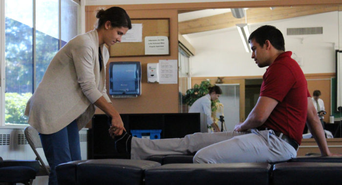 Students learning chiropractic skills hands-on