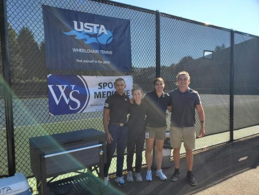 Sports medicine students in front of tennis court
